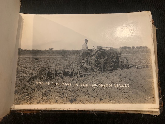 A farmer driving an early model tractor with metal wheels in a field in the Rio Grande Valley.