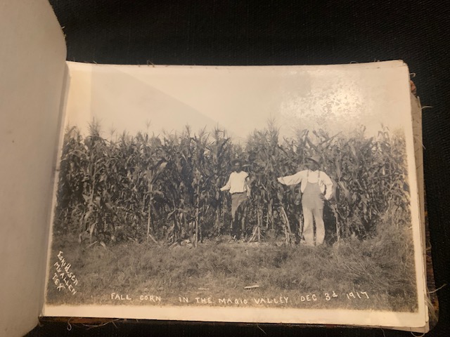 Two men, one Black and one white, standing in a tall field of Fall Corn in the Magic Valley on December 3, 1917.