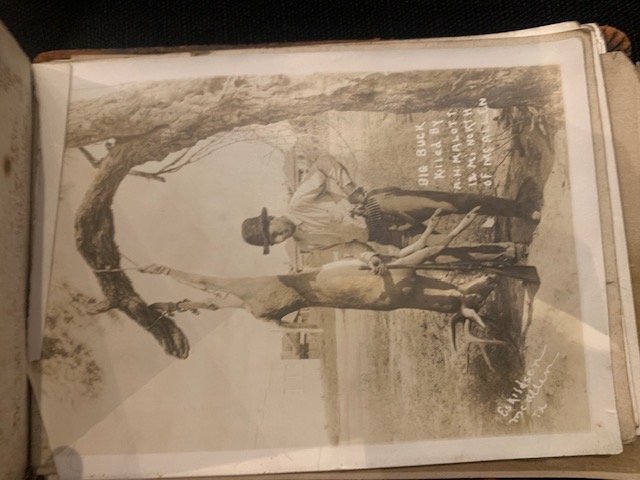 A hunter named A.H. Malott with a large buck