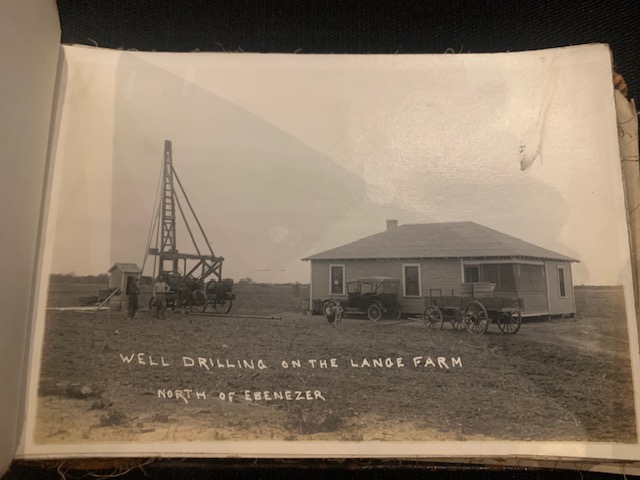A well drilling rig operating next to a farmhouse on the Lange Farm, north of Ebenezer.